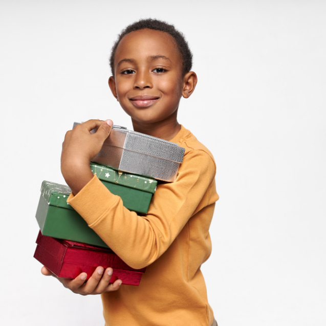 portrait-cheerful-african-boy-carrying-boxes-receiving-presents-looking-front-with-joyful-happy-smile
